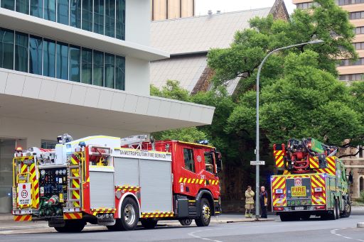 Two fire trucks parked in front of a building.